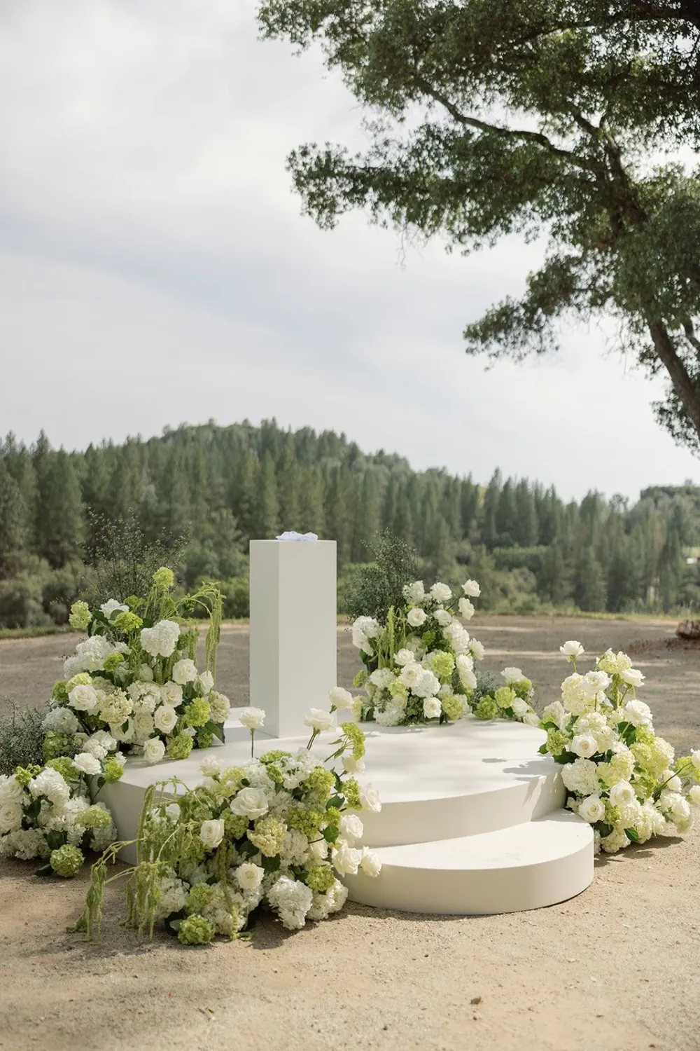 Ceremony stage and lush floral arrangements