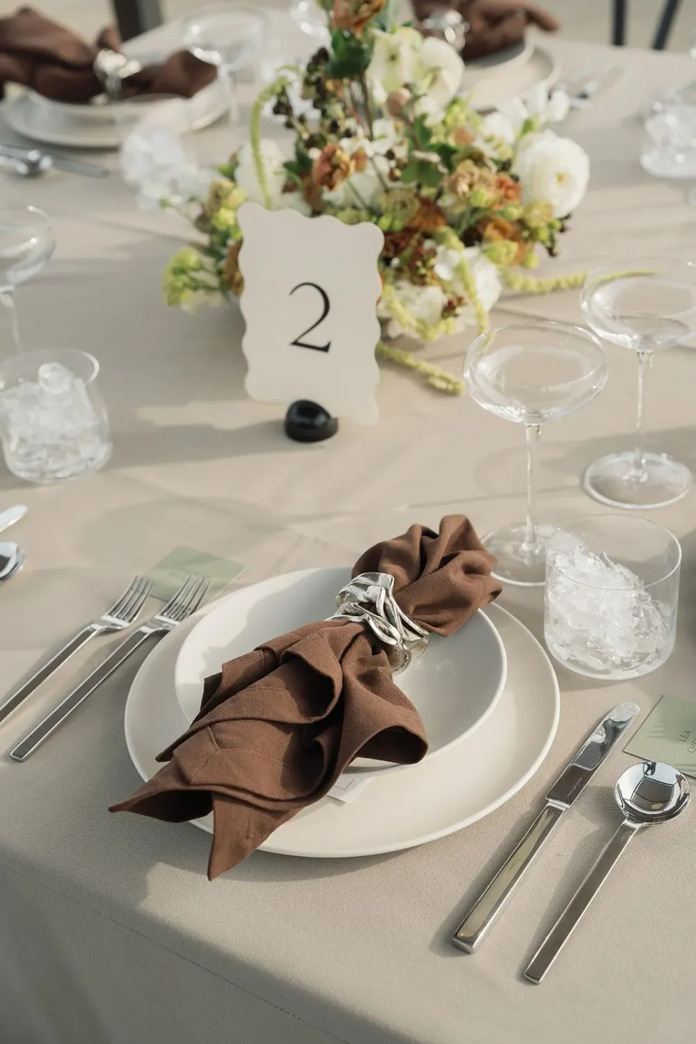 Place setting with a napkin and curved table number